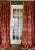 Custom interlined linen damask drapery panels with French pinch pleats and matching tiebacks, sourced from a...