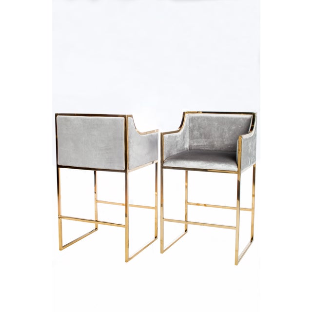 Gray velvet upholstered counter chair features a gold stainless steel frame. Seat height 26"