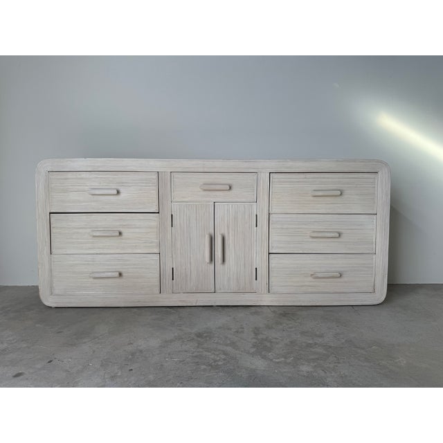 Striking 1970s Vintage dresser designed in the style of Gabriella Crespi, featuring an elegant pencil reed rattan exterior...