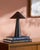 Illuminate your space with a touch of retro flair with the Nomelle accent table lamp. Standing at a charming 12 inches...
