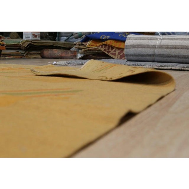 This 6 x 8 feet area rug is a flat weave wool rug featuring a primary color palette of ivory, beige, cream, and white. The...