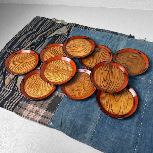 This exceptional set of 10 vintage Japanese wooden plates beautifully combines refined lacquer craftsmanship with the pure...