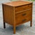 Sleek mid century modern walnut nightstand circa 1960s. Features a brutalist inspired top drawer, one deep drawer for...