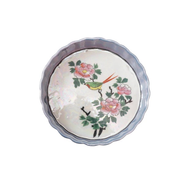 A set of seven Japanese Kiri-Mon lusterware serving dish set. Made of porcelain and arranged to fit six dishes around a...