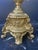 A stunning, completely matched pair of vintage mid-century Italian brass table lamps styled in the ornate Neoclassical and...