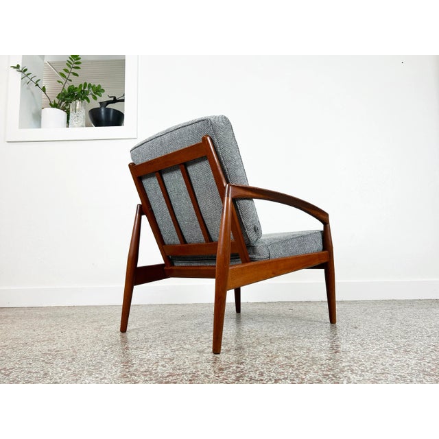 Vintage 'Paper Knife' chair in teak by Kai Kristiansen for Magnus Olesen. Cushions have been newly upholstered in a...