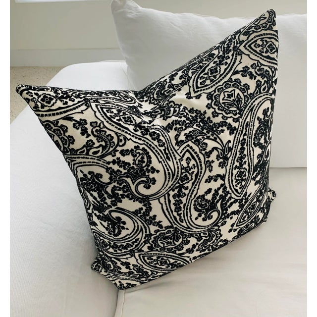 Lovely accent pillow in a black velvet paisley pattern on white textured background, with a fluffy, full down insert by...