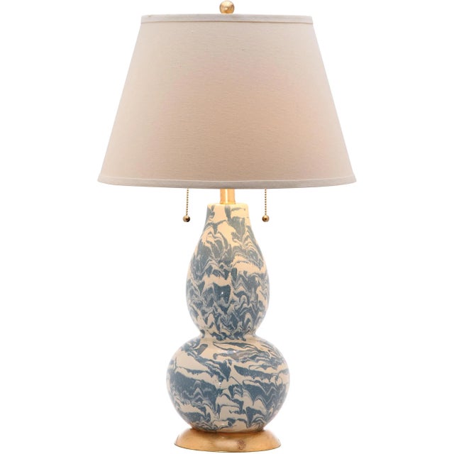 Dress up your home with the designer look of marble recreated in the elegant blue and white glass table lamp. Crafted of...