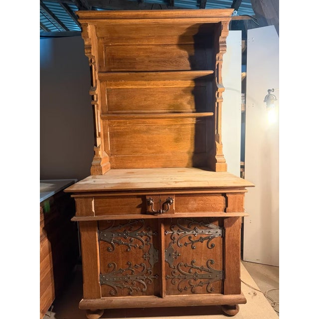 A beautiful, antique Historicist sideboard, immediately catching the eye with its opulent iron fittings on the front...