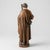 Saint Joseph is depicted standing with a staff held close to the body and one hand resting over his chest. Layered brown...
