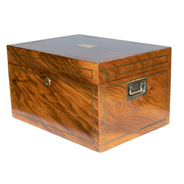 With rectangular hinged top with brass stringing and central blank inscription plaque. Interior with B&H label and tin...