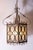This is a stunning pair of early 20th-century French iron hanging lanterns, showcasing exquisite craftsmanship and design....