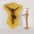 Crucified Christ in finely carved boxwood mounted on a panel covered in yellow fabric. This piece is attributed to the...