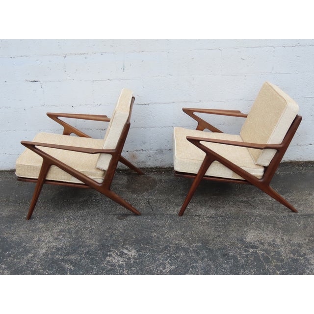 This Rare Pair of Lounge Chairs are made out of wood, solid wood, and fabric. These chairs have Danish Modern style and...