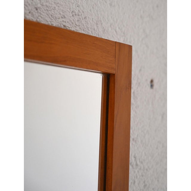 Danish mirror produced in the 1960s with teak wood frame. A minimalist design typical of the Scandinavian style of the...