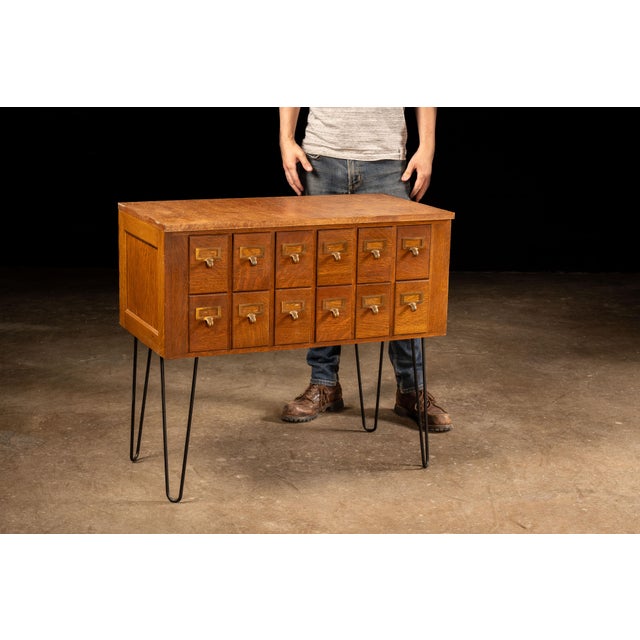 Mid-century Danish card catalog. This piece features twelve catalog drawers of uniform size, each with a steel interior...