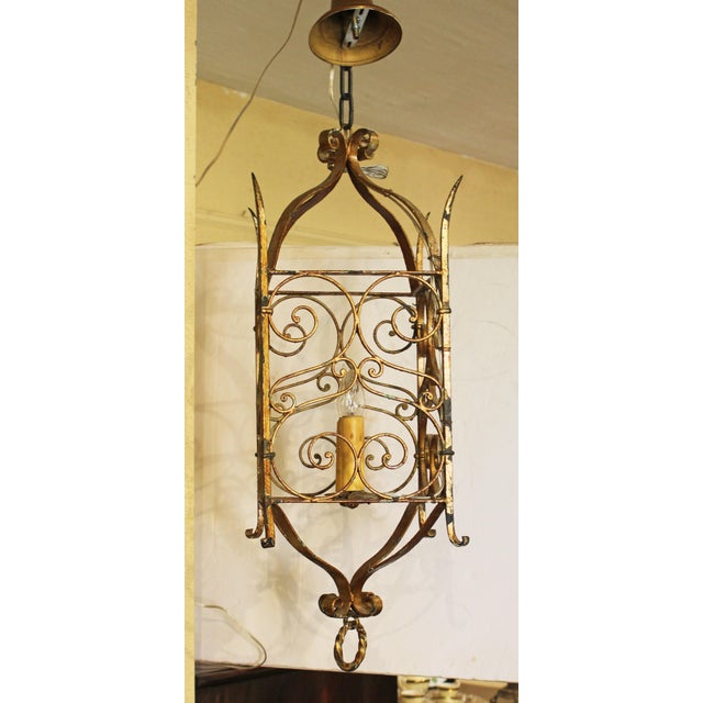 Early 20th century French gilt iron double light hanging lantern. Each side with connected S-scrolls; corners with pointed...