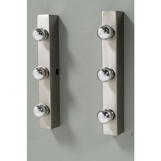 Pair of 2 mirror lamps in stainless steel. These are mostly being used in the dressing room of the theatre. Of course you...