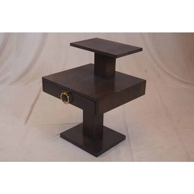 The Stacked End Tables present a bold, architectural take on mid-century modern design. Crafted in richly toned wood, each...