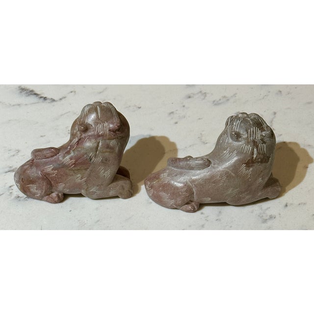 An exceptional, beautifully matched pair of vintage hand-carved soapstone tiger figurines, functioning traditionally as...