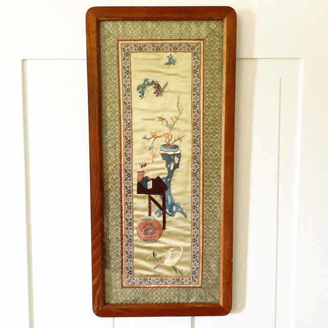 A beautiful late 19th century Asian silk embroidered panel with a wonderful scene of an artists table with paint brushes,...