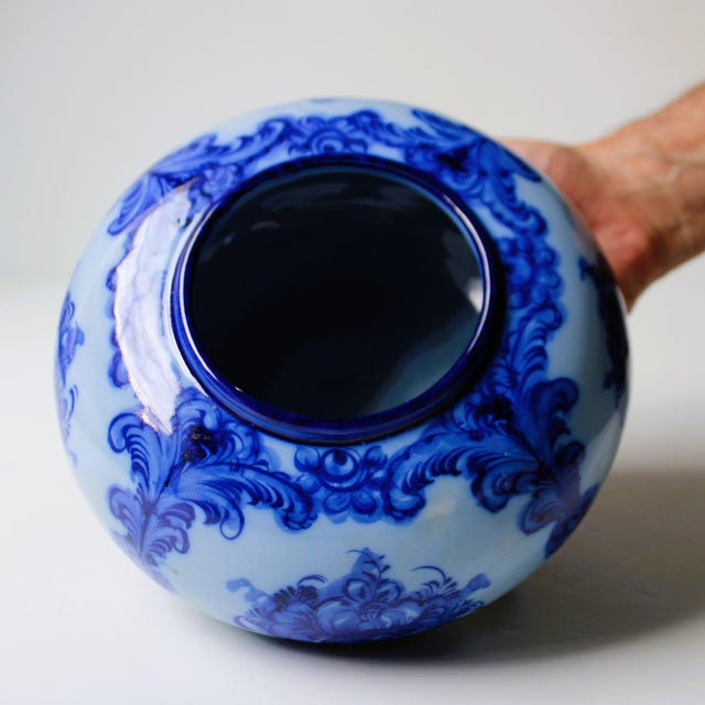 Exceptional hand painted (flow blue) style rounded porcelain vase. With an elegant vibrant cobalt blue colorway, and...