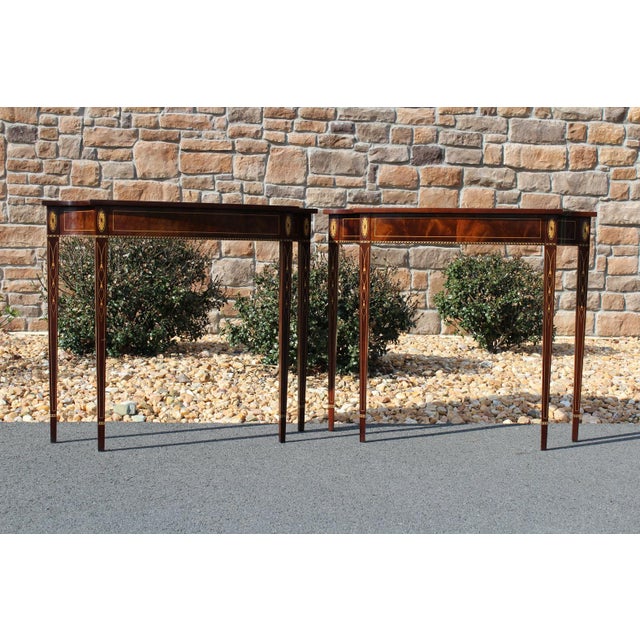 The quality of Stickley craftsmanship is exemplified in this pair of consoles adorned with delicate inlays. The flame...
