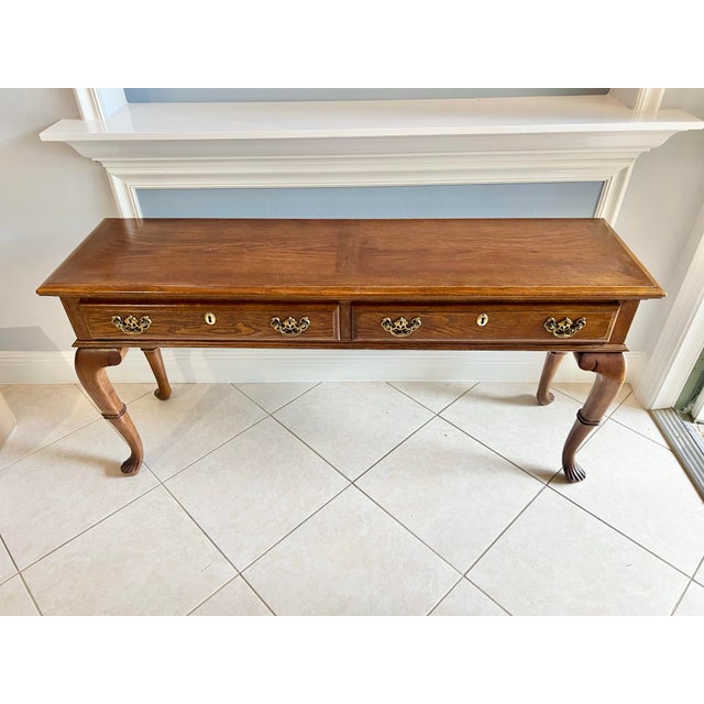Add a touch of timeless sophistication to your home with this beautifully crafted wooden console table. Featuring a rich,...