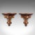 This is a pair of vintage decorative wall brackets. An English, gilt painted mahogany clock or lamp shelf in Italianate...