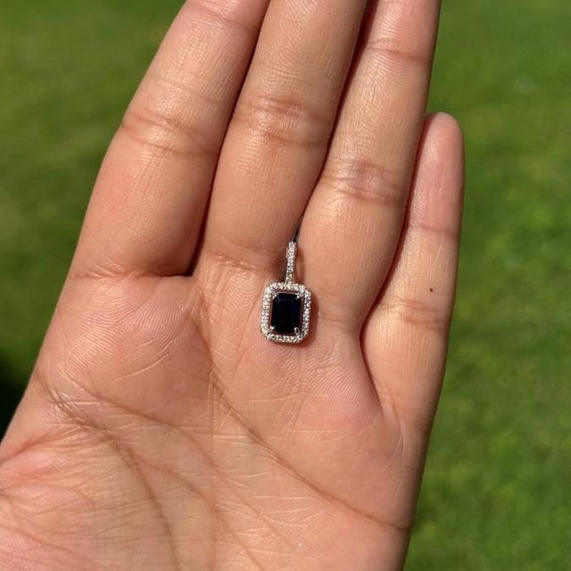 This elegant pendant features a 1.21 carat emerald-cut blue sapphire set in 14K white gold. The sapphire measuring 5 x 7...