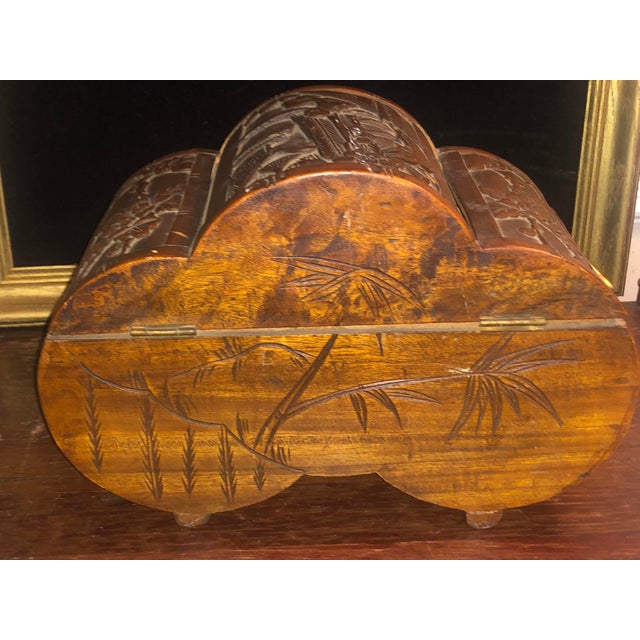 A hand-carved solid camphor wood box featuring an unusual scalloped "tri-section" domed silhouette and low integrated...