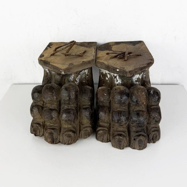 Pair of antique Italian hand-carved wooden corbels in the form of lion paws. A decorative architectural salvage piece with...
