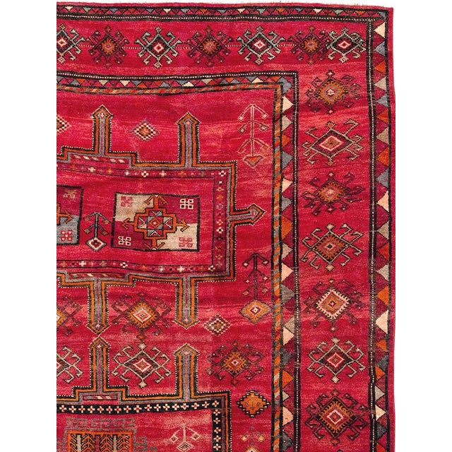 This Mid-20th century Turkish Anatolian room-size carpet presents a vibrant, highly structured composition across a richly...