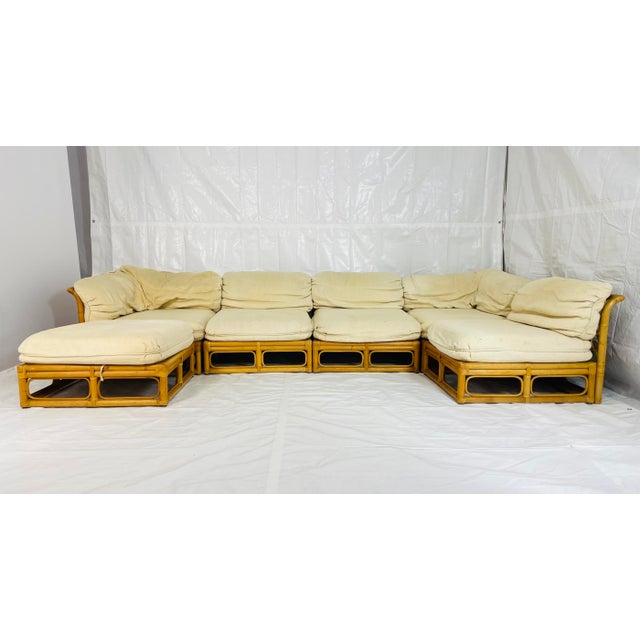 A versatile 6-piece modular sofa crafted with a warm honey-toned bamboo frame and upholstered in its original cream-...