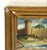 Small vintage miniature landscape painting depicting a tower and stone wall along a shoreline or riverbank under a cloudy...