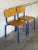 This set of two industrial stacking chairs features clean curved seats and supportive backrests. Their space-saving design...