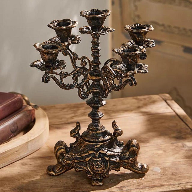 This ornate five-arm candelabra brings a touch of vintage European elegance to any tabletop or mantel. Crafted from cast...