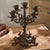 This ornate five-arm candelabra brings a touch of vintage European elegance to any tabletop or mantel. Crafted from cast...