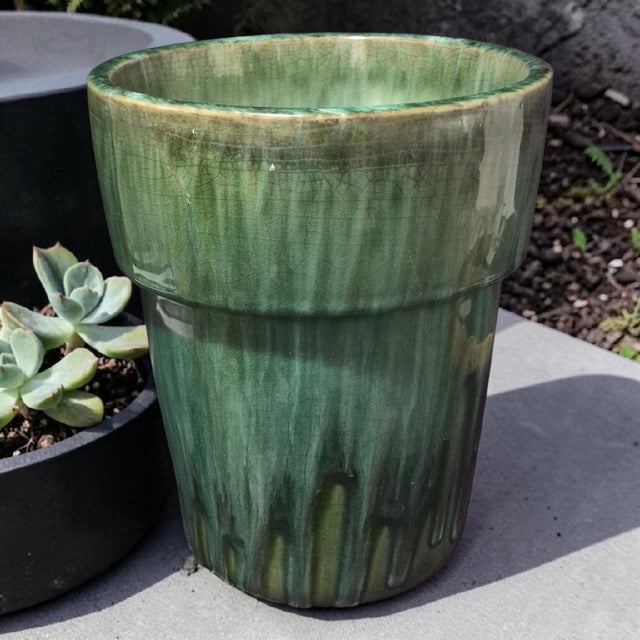 This vintage mid-century green glazed terra-cotta pottery cache pot planter exudes a charming Mid-Century Modern style...