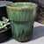 This vintage mid-century green glazed terra-cotta pottery cache pot planter exudes a charming Mid-Century Modern style...