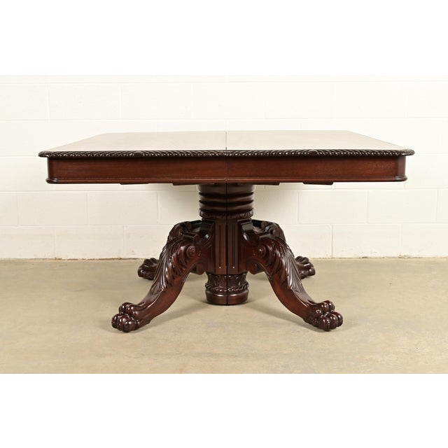 An outstanding monumental antique Victorian, American Empire, or Renaissance Revival split pedestal extension dining table...