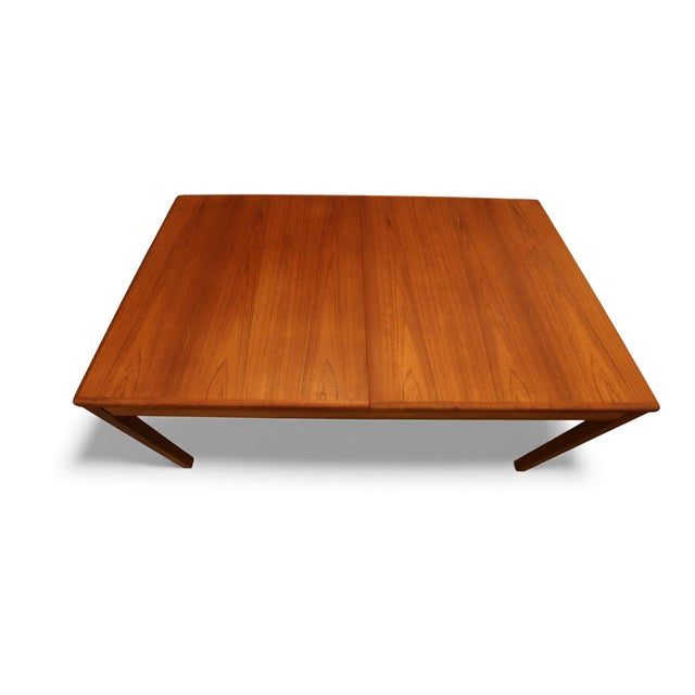 A Danish teak dining table with a very practical butterfly top that folds out of the table when in use. The innovative...