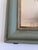 The mirror features a green-painted wooden frame with a gilt edge and a gently curved top characteristic of the Louis...