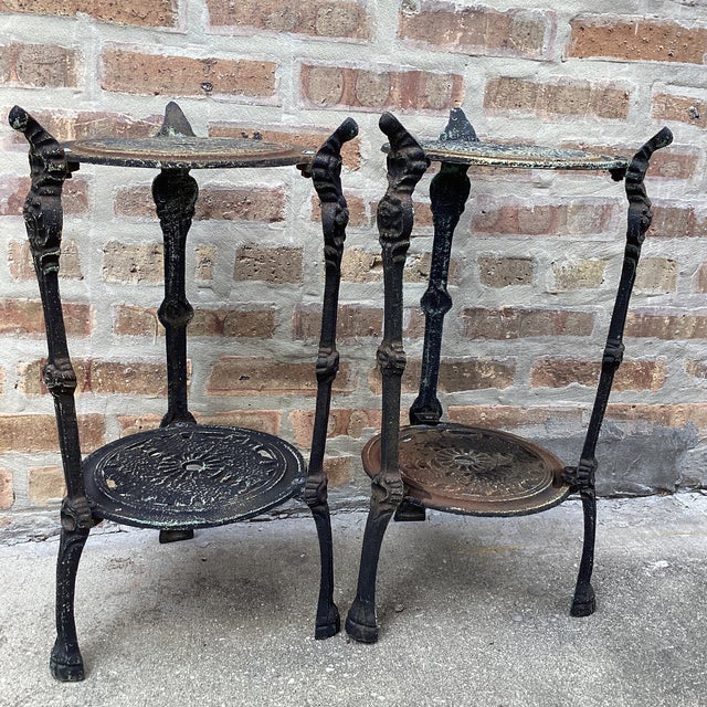 High Victorian cast iron plant stand side table, the pierced circular shelves molded with scrollwork legs. Durable cast...