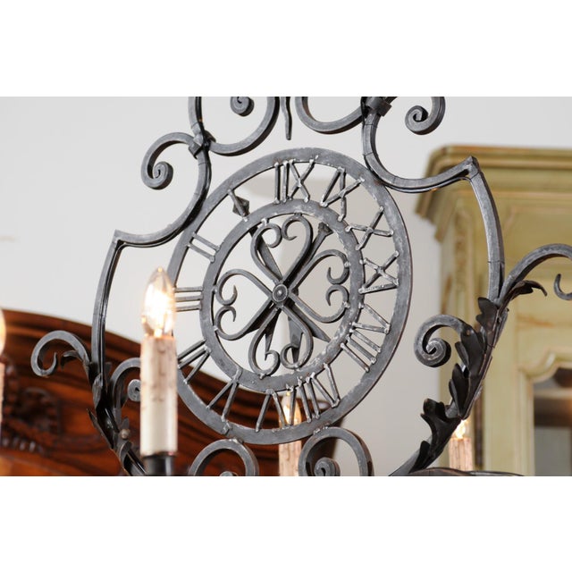 Early 20th Century French 12-Light Wrought-Iron Chandelier with Clock Motif and Scrolling Armature For Sale In Atlanta - Image 6 of 12