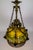 An expertly crafted, late 19th century, mosaic-style slag glass pendant light in a crowned, umbrella shape with subtle...