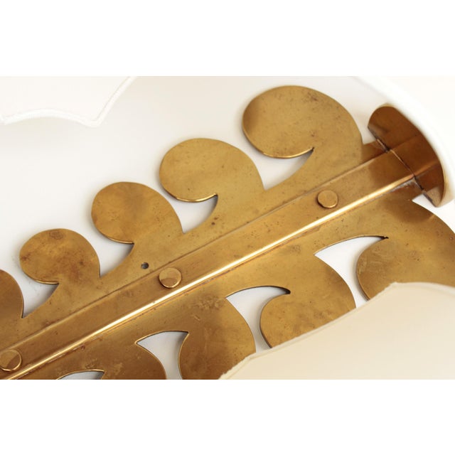 A large spanish wall lamp made of brass and fabric lampshades. brass surface with typical patina from aging. the fabric...