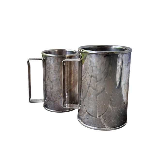 A sophisticated pair of vintage silver-plated tankards by the prestigious Brazilian silversmith, St. James. This set...
