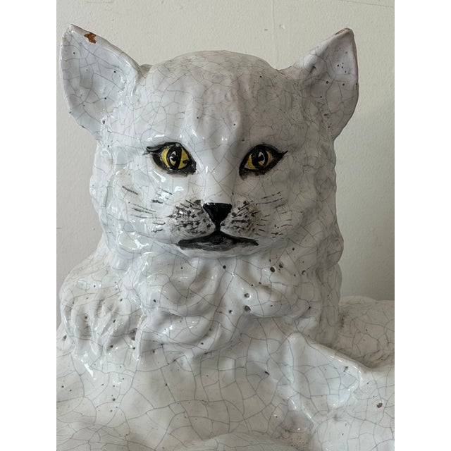 An exceptional monumental Italian hand-crafted terracotta sculpture depicting a reclining mother cat protectively...