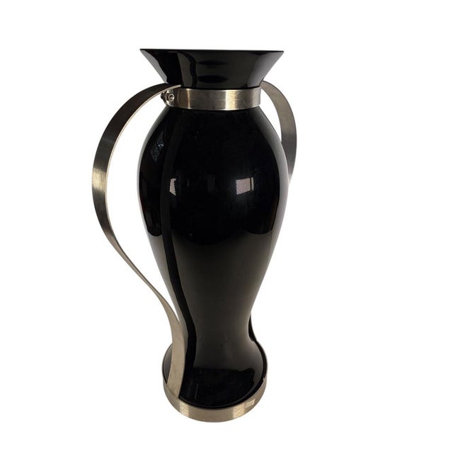 A striking pair of black glass and stainless steel vases with sleek modern lines and sophisticated proportions. Their...